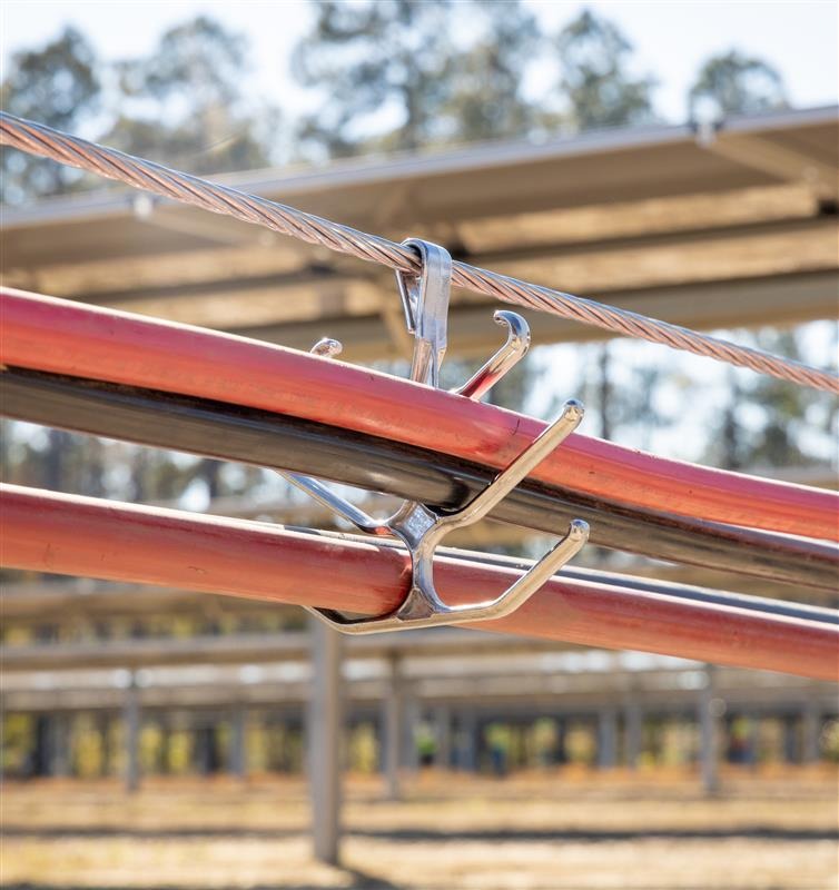 An above-ground wire management system for a solar tracker project.