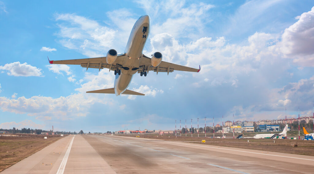 An airplane takes off from an airport. Airplane safety is important to keep in mind when traveling for work.