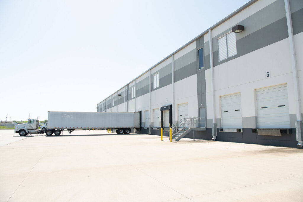 Ampacity warehouse loading dock with freight trailer supporting project logistics and material delivery.